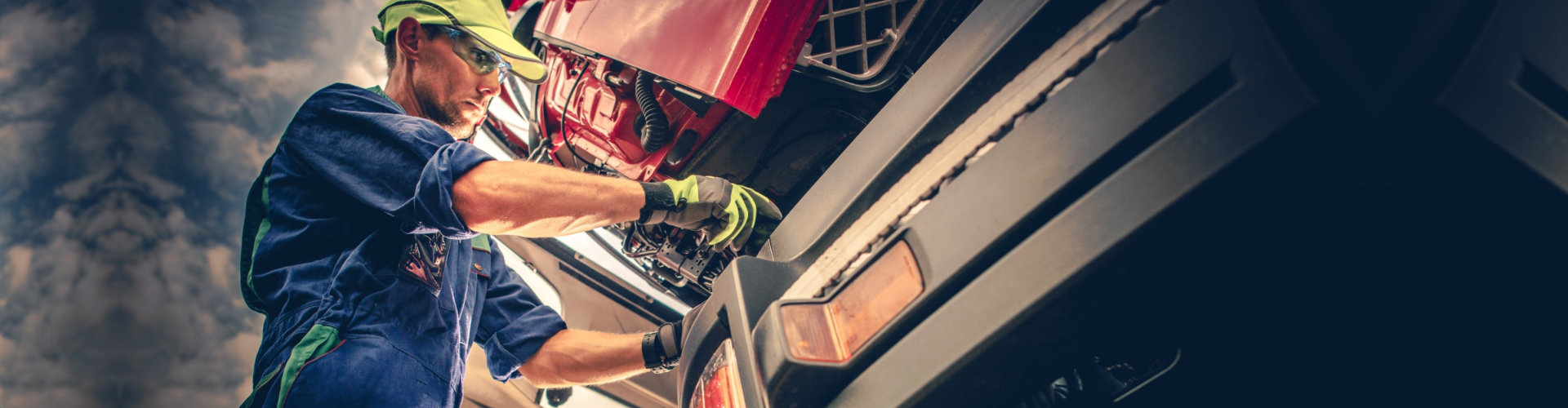 Semi Truck Maintenance. Caucasian Truck Service Worker in His 30s Performing Scheduled Recall Maintenance.